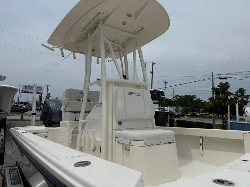 Slide: The Image of 2023 Pathfinder 2500 Hybrid boat with T-top and seating, displayed outdoors. - 11