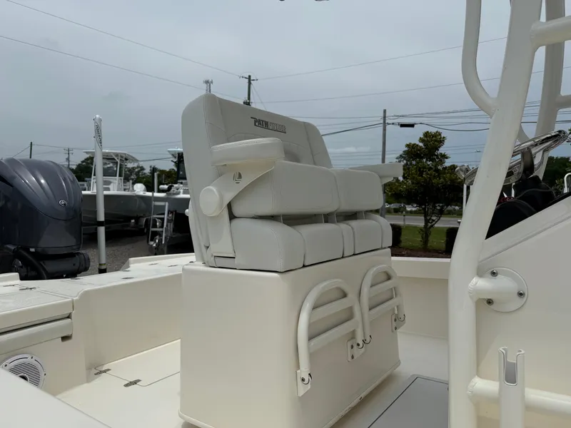Slide: The Image of 2023 Pathfinder 2500 Hybrid boat with cushioned seating and sleek design. - 12