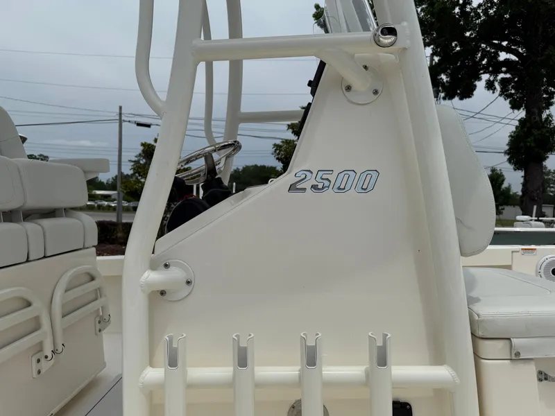 Slide: The Image of 2023 Pathfinder 2500 Hybrid boat interior with seating and steering wheel. - 13