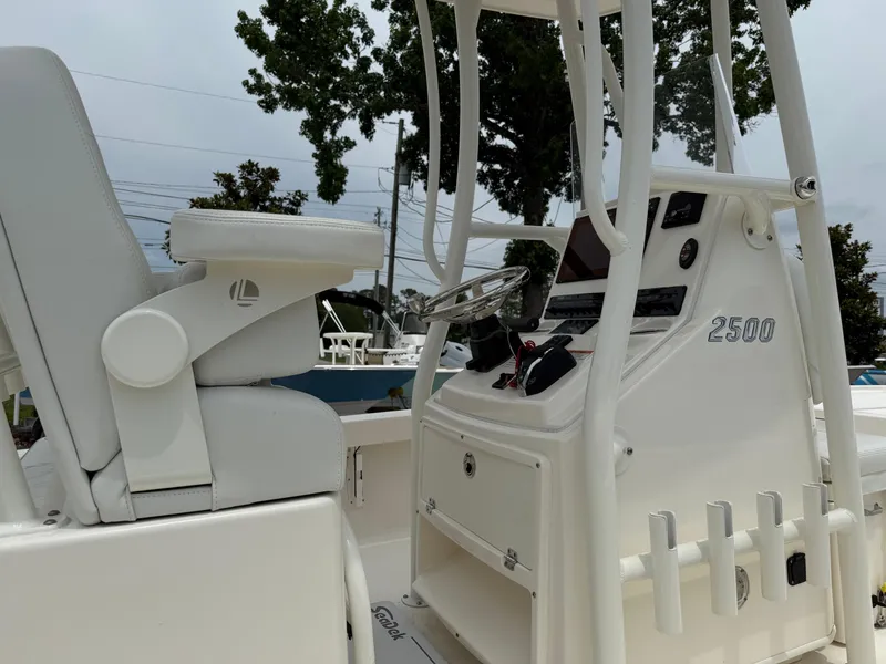 Slide: The Image of 2023 Pathfinder 2500 Hybrid boat console with steering wheel and seating. - 14