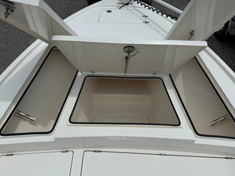 Slide: The Image of 2023 Pathfinder 2500 Hybrid boat storage compartments open, showcasing spacious interior design. - 16