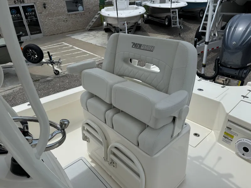 Slide: The Image of 2023 Pathfinder 2500 Hybrid boat seat with armrests, docked near other boats. - 24