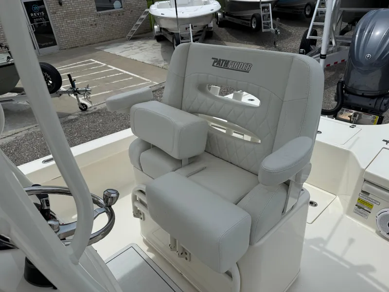 Slide: The Image of Captain's chair on 2023 Pathfinder 2500 Hybrid boat, featuring cushioned seating and armrests. - 25