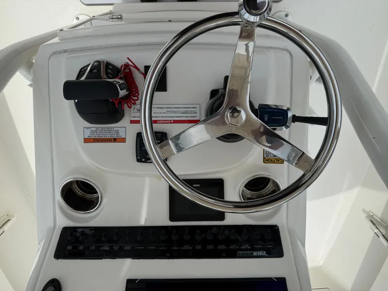 Slide: The Image of 2023 Pathfinder 2500 Hybrid boat console with steering wheel and controls. - 27