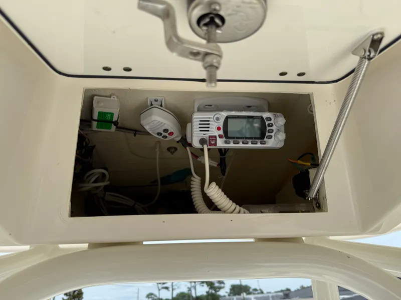 Slide: The Image of 2023 Pathfinder 2500 Hybrid boat console with electronic equipment and wiring. - 28