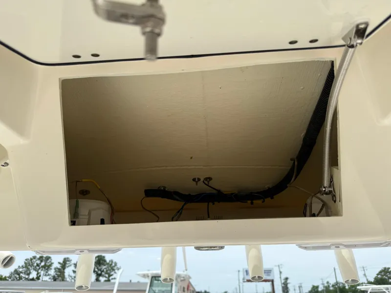 Slide: The Image of Open compartment of 2023 Pathfinder 2500 Hybrid boat, showing internal wiring and components. - 29