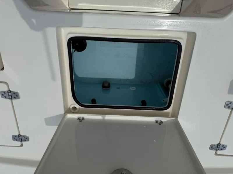 Slide: The Image of 2023 Pathfinder 2500 Hybrid boat storage compartment with open hatch, showcasing interior details. - 31