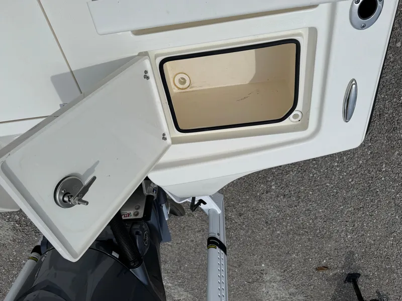 Slide: The Image of 2023 Pathfinder 2500 Hybrid boat storage compartment with open hatch and key lock. - 32