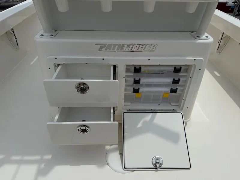 Slide: The Image of 2023 Pathfinder 2500 Hybrid boat storage compartments with open drawers and tackle boxes. - 35