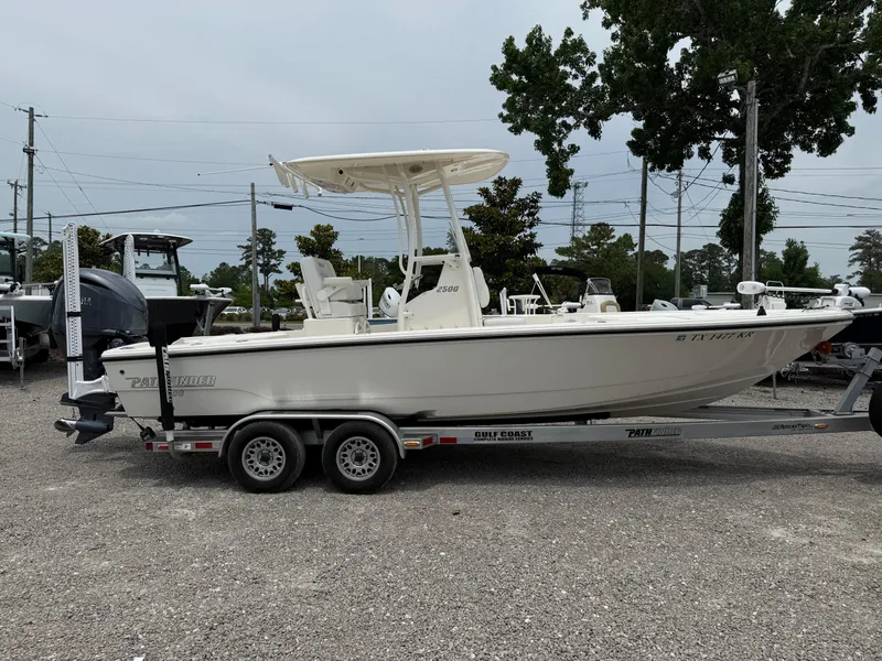 Slide: The Image of 2023 Pathfinder 2500 Hybrid boat on trailer, parked outdoors. - 6