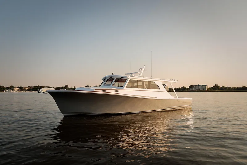 The Image of 2022 Composite Yacht CY46 on calm water at sunset. - 1
