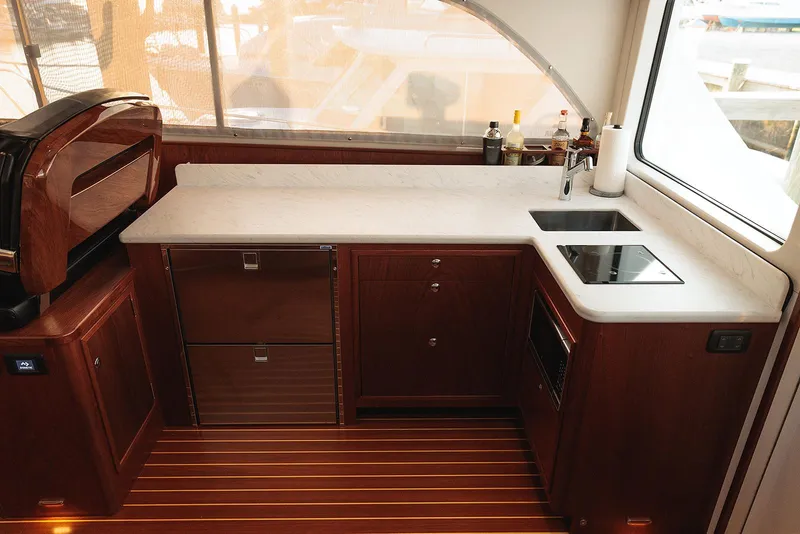 Slide: The Image of Luxurious kitchen in 2022 Composite Yacht CY46 with modern appliances and elegant wood finish. - 11