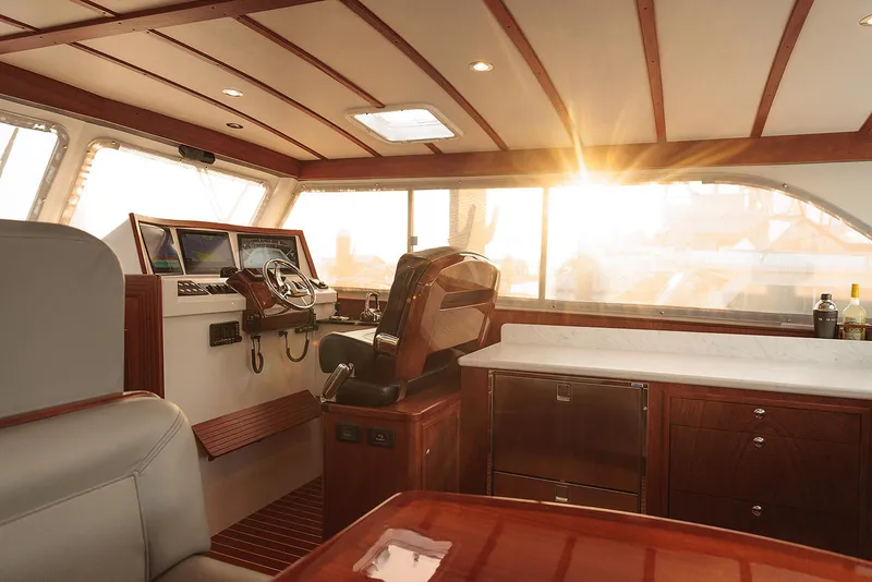 Slide: The Image of Luxurious 2022 Composite Yacht CY46 interior with elegant wood finish and sunset view. - 12
