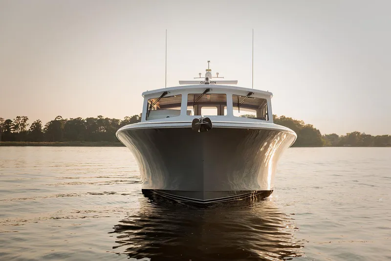 Slide: The Image of Front view of 2022 Composite Yacht CY46 on calm water at sunset. - 2