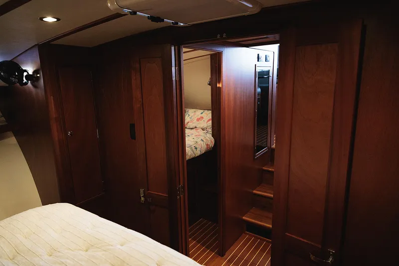 Slide: The Image of Interior of 2022 Composite Yacht CY46, featuring wooden paneling and cozy cabin space. - 23