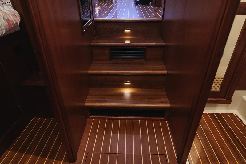 Slide: The Image of Luxurious wooden staircase inside 2022 Composite Yacht CY46, featuring elegant lighting and polished finish. - 27