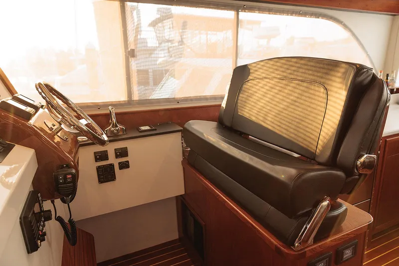 Slide: The Image of Luxurious helm station of 2022 Composite Yacht CY46 with leather seating and wooden accents. - 8