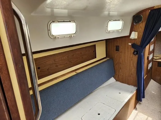 Slide: The Image of Interior of a 1977 Bombay Express boat with blue seating and wooden accents. - 10