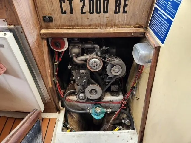 Slide: The Image of Engine compartment of a 1977 Bombay Express boat, showing mechanical components and wiring. - 8