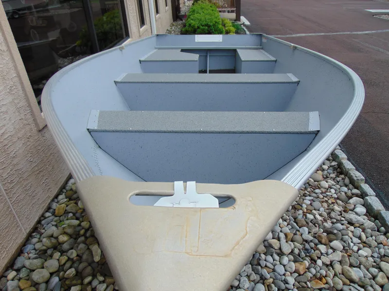 Slide: The Image of 2024 Crestliner 1469 Outreach boat displayed on decorative stones. - 12