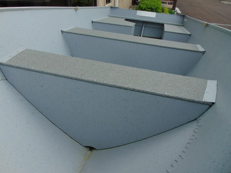 Slide: The Image of 2024 Crestliner 1469 Outreach boat interior with bench seating and durable construction. - 13