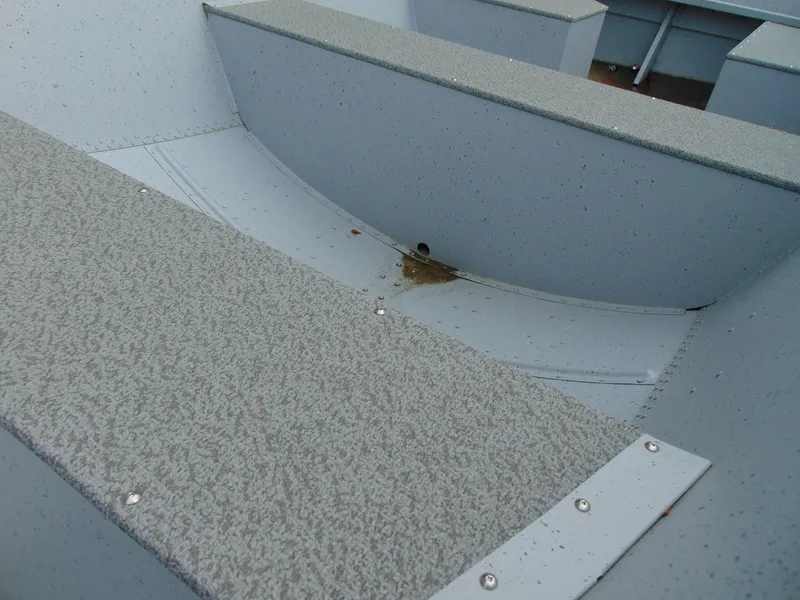 Slide: The Image of 2024 Crestliner 1469 Outreach boat interior, showcasing durable seating and flooring. - 14