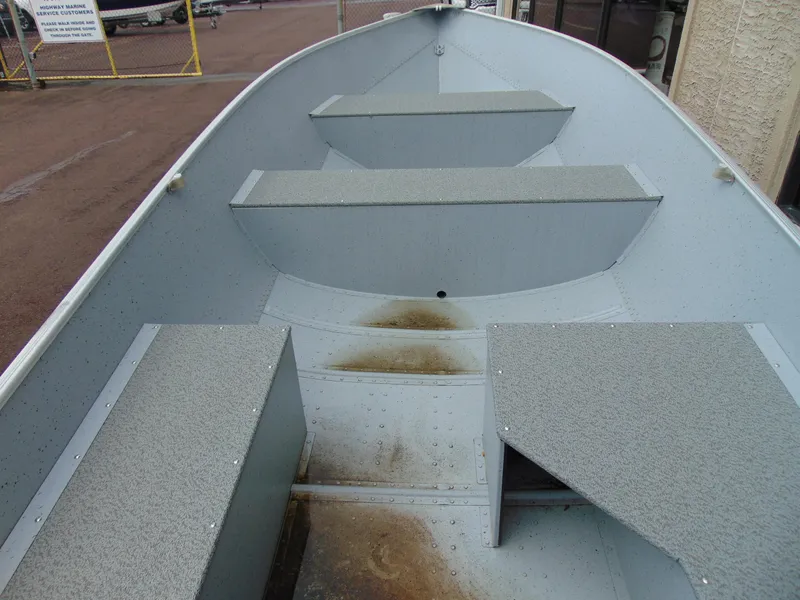 Slide: The Image of 2024 Crestliner 1469 Outreach boat interior with bench seating and textured flooring. - 9