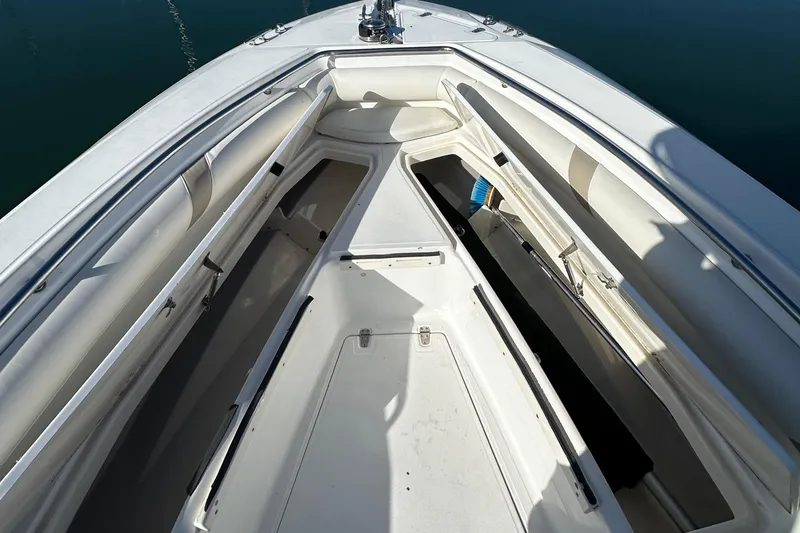 Slide: The Image of 2004 Boston Whaler 270 Outrage boat interior with spacious seating and storage compartments. - 13