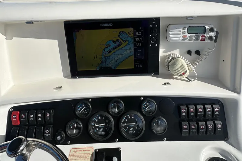 Slide: The Image of Dashboard of a 2004 Boston Whaler 270 Outrage with navigation and control instruments. - 16