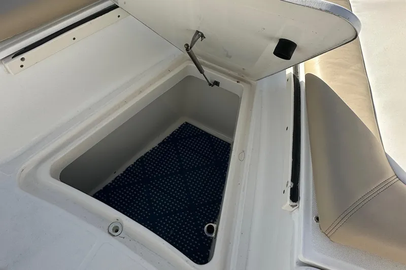 Slide: The Image of Open storage compartment on a 2004 Boston Whaler 270 Outrage boat. - 23