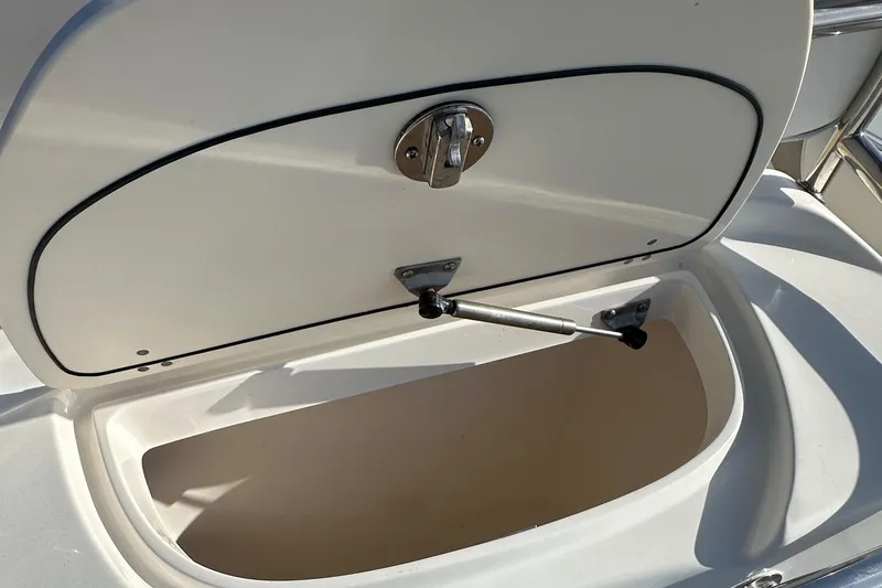 Slide: The Image of Open storage compartment on a 2004 Boston Whaler 270 Outrage boat. - 26