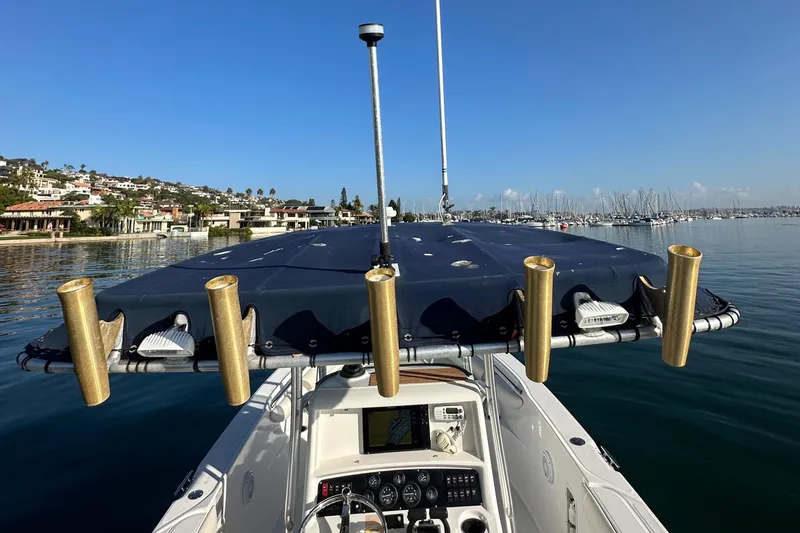 Slide: The Image of Boston Whaler 270 Outrage 2004 boat with rod holders, docked in a scenic marina. - 33