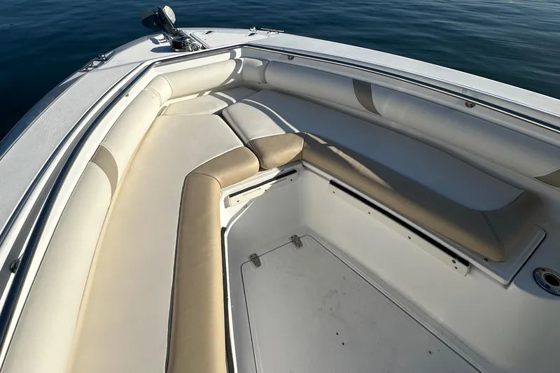 Slide: The Image of 2004 Boston Whaler 270 Outrage boat interior with cushioned seating and open deck. - 35