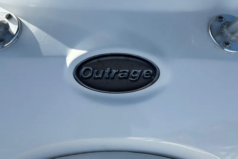 Slide: The Image of Boston Whaler 270 Outrage 2004 boat emblem on white surface. - 36
