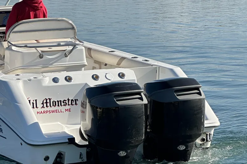 Slide: The Image of 2004 Boston Whaler 270 Outrage boat with dual engines on calm water. - 37