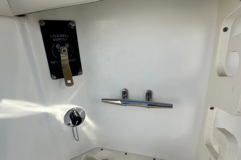 Slide: The Image of Livewell supply and cleat on 2004 Boston Whaler 270 Outrage boat interior. - 39