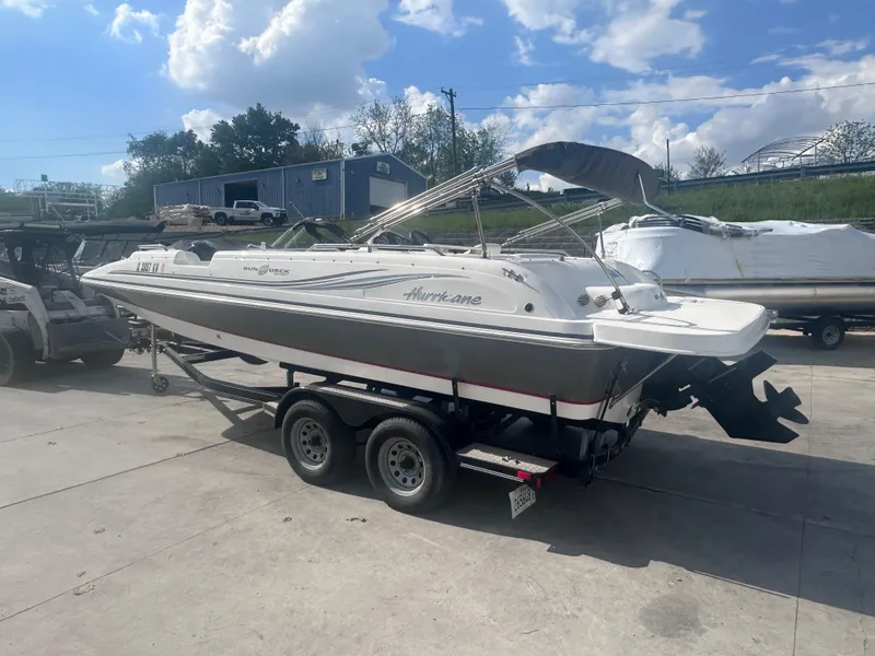 Slide: The Image of 2012 Hurricane SD 201 boat on trailer, parked outdoors under a partly cloudy sky. - 3