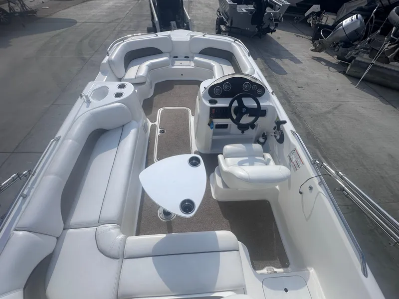 Slide: The Image of 2012 Hurricane SD 201 boat interior with white seating and steering console. - 6
