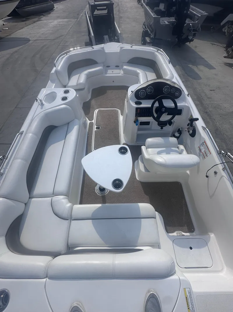 Slide: The Image of 2012 Hurricane SD 201 boat with white seating and modern dashboard, docked outdoors. - 7