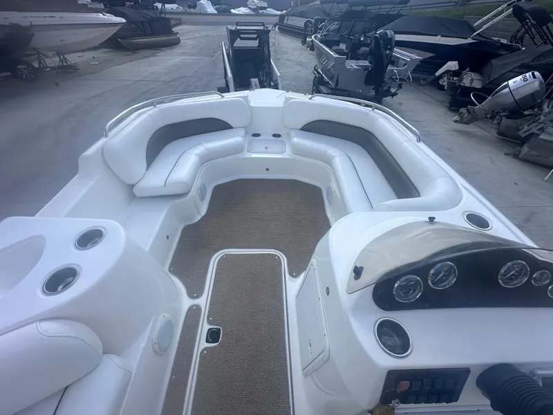 Slide: The Image of 2012 Hurricane SD 201 boat interior with seating and dashboard, parked in a marina. - 9