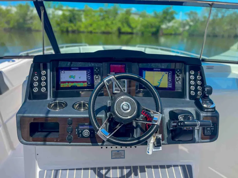Slide: The Image of Helm of 2021 Chaparral 300 OSX boat with modern navigation displays and controls. - 10