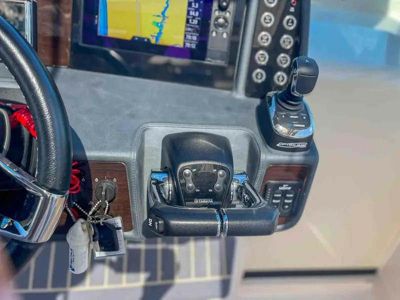Slide: The Image of Control panel of 2021 Chaparral 300 OSX boat with steering and navigation equipment. - 18
