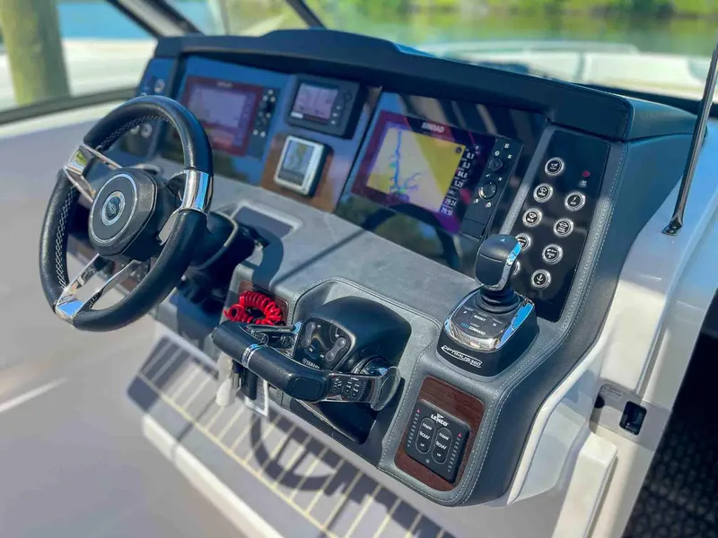 Slide: The Image of Helm of 2021 Chaparral 300 OSX boat with modern controls and navigation displays. - 20