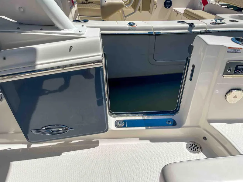 Slide: The Image of 2021 Chaparral 300 OSX boat interior with open storage compartment and sleek design. - 38