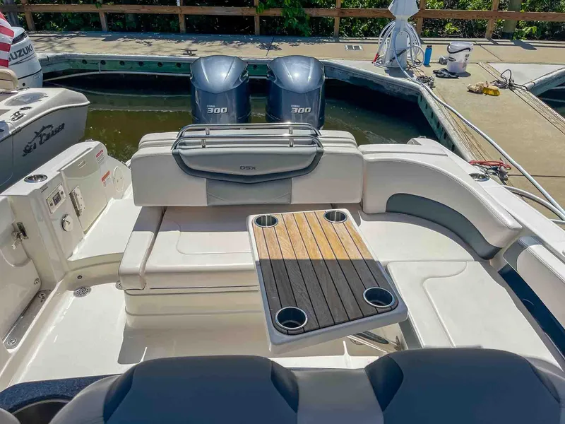 Slide: The Image of 2021 Chaparral 300 OSX boat with dual engines and seating area at the dock. - 42