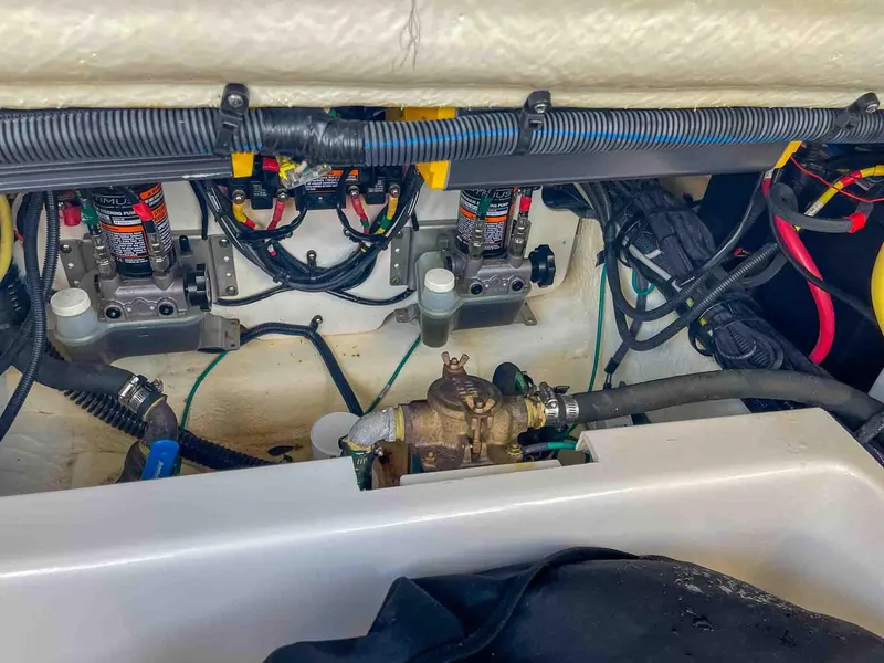 Slide: The Image of Engine compartment of a 2021 Chaparral 300 OSX boat, showcasing wiring and mechanical components. - 47