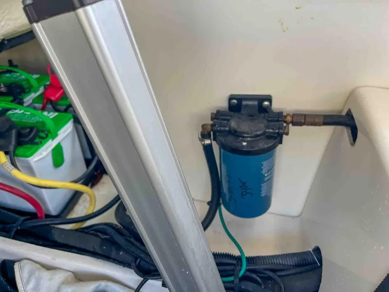 Slide: The Image of 2021 Chaparral 300 OSX engine compartment with filter and battery setup. - 49