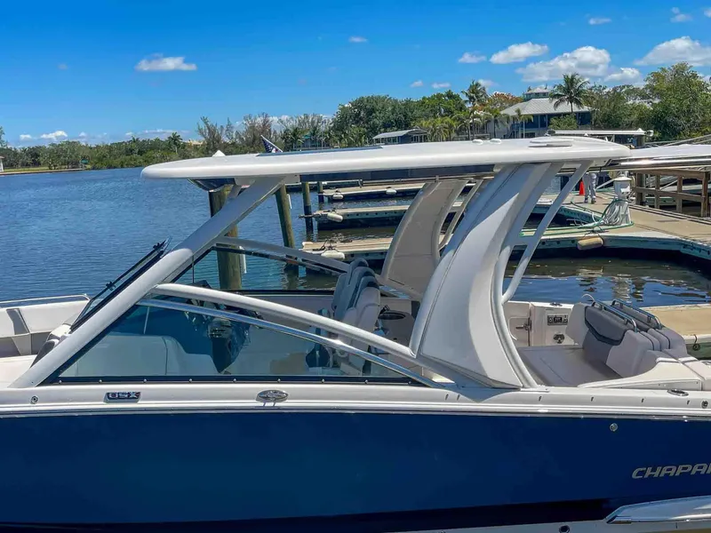 Slide: The Image of 2021 Chaparral 300 OSX boat docked by a scenic waterfront. - 5