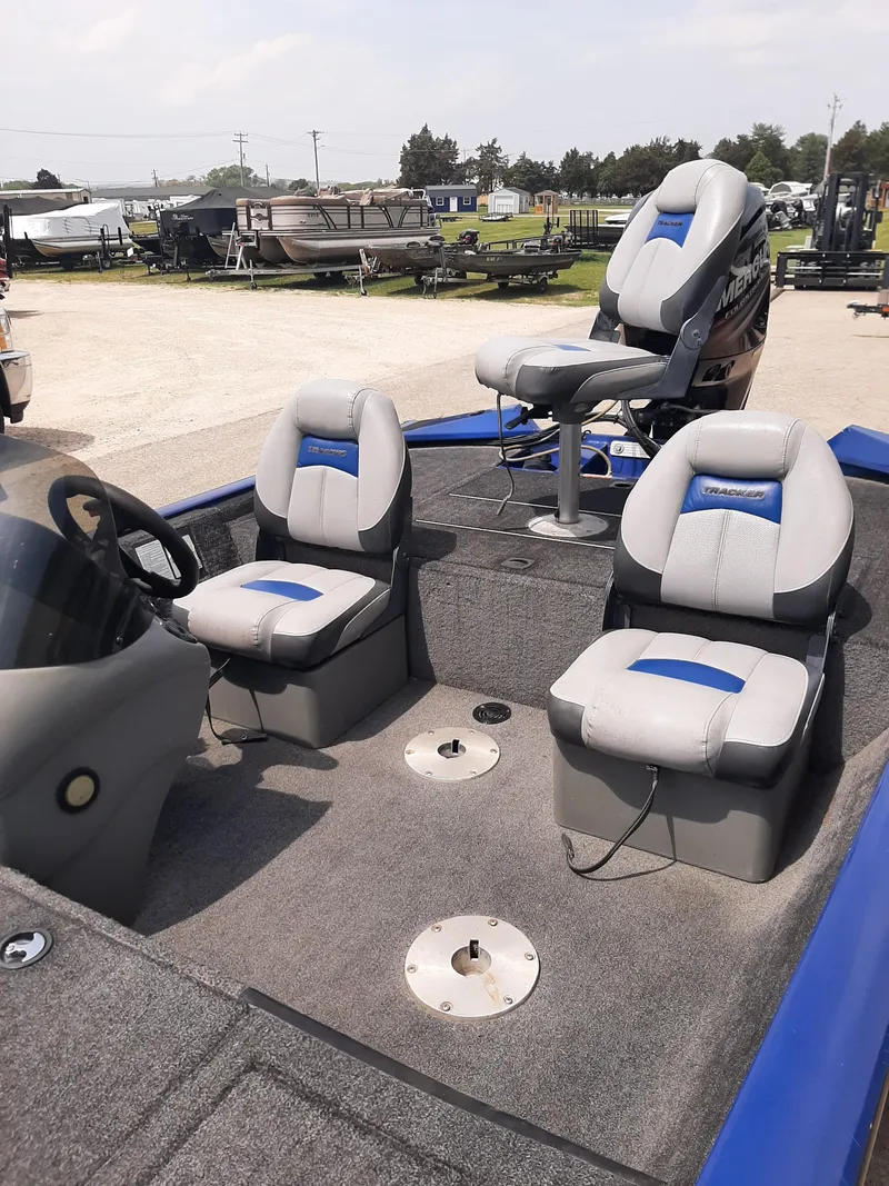 Slide: The Image of 2016 Bass Tracker 175TF boat interior with three cushioned seats and steering console. - 5