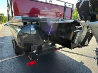 Slide: The Image of 2024 Regency 250 DL3 pontoon boat rear view with motor and trailer. - 1